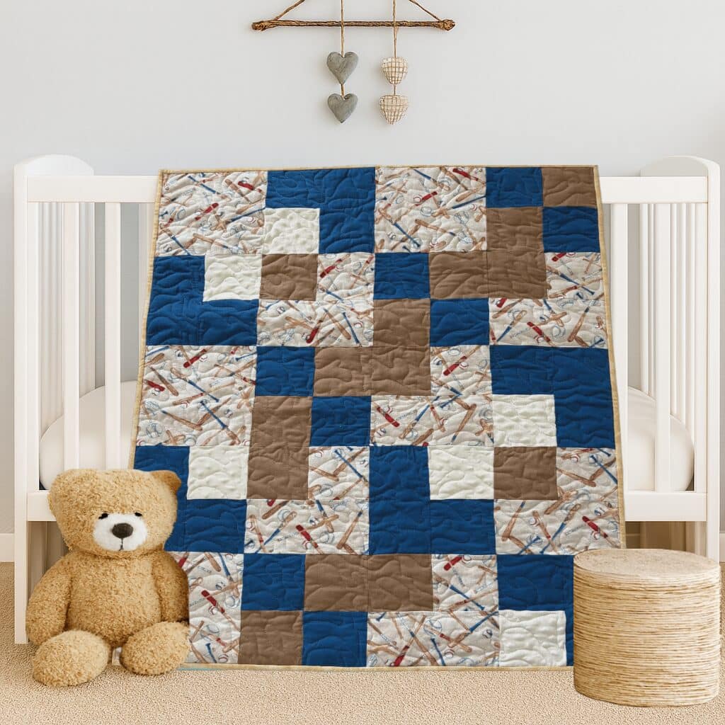 Baseball Games Baby Quilt draped on white crib with teddy bear