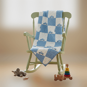 blue trucks baby quilt on chair