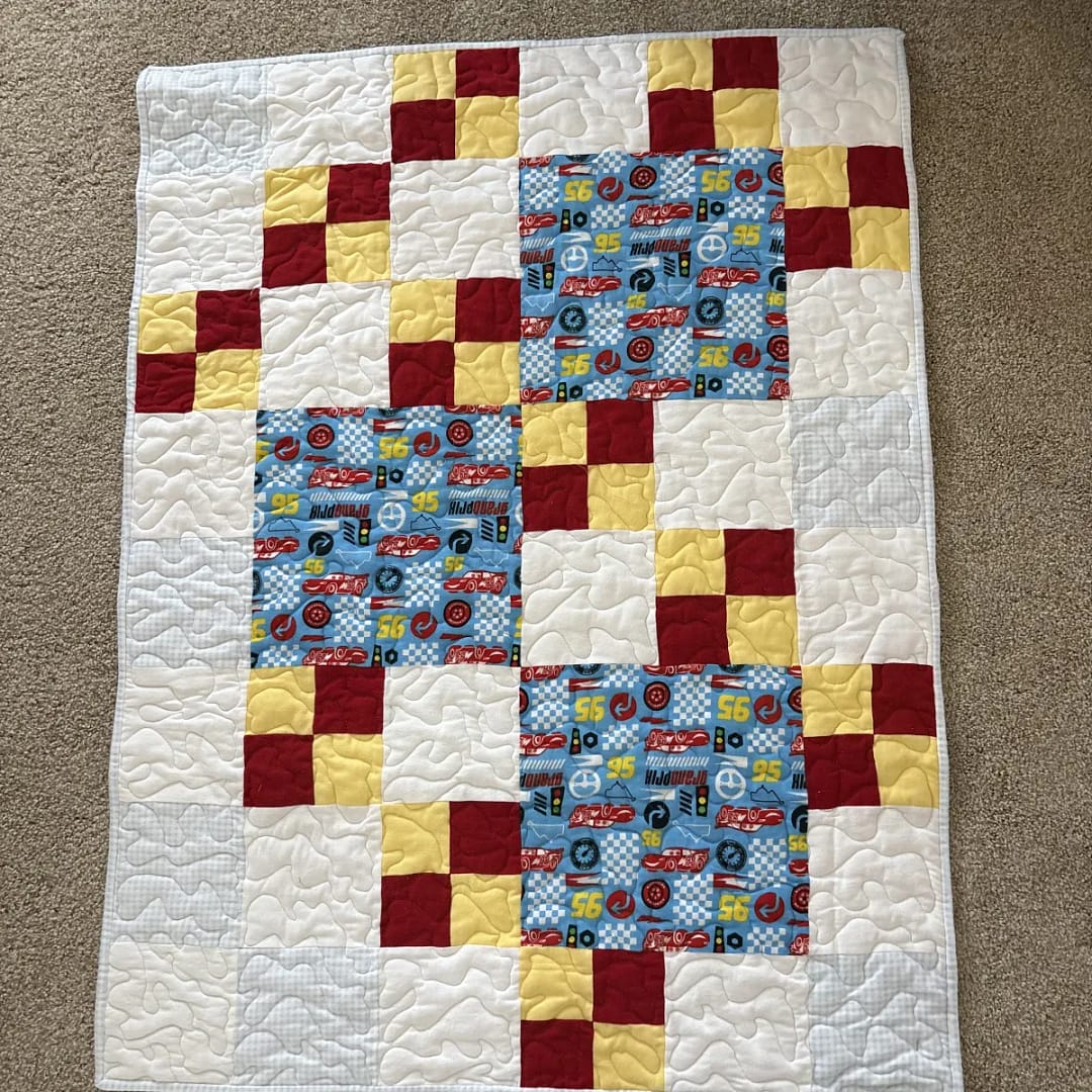 Grand Prix Baby Quilt full view of quilt on floor