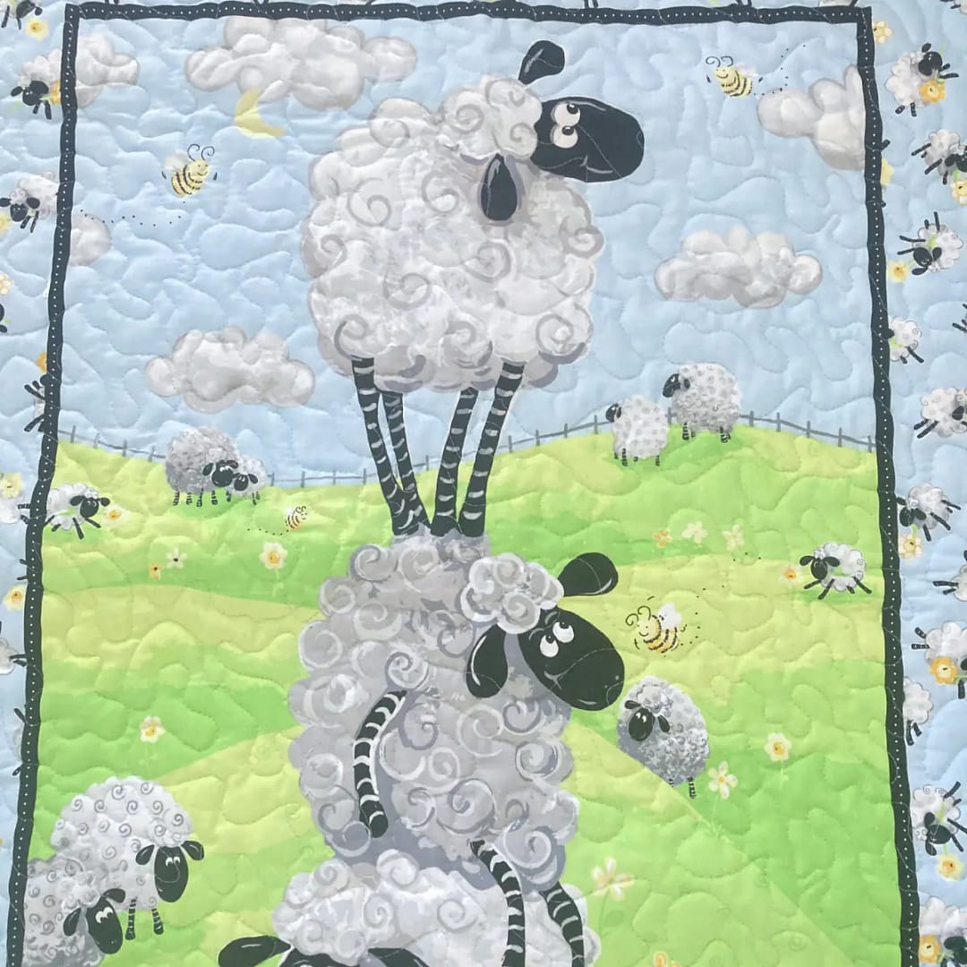 Sheep Meadow Baby Quilt Detail of stacked sheep