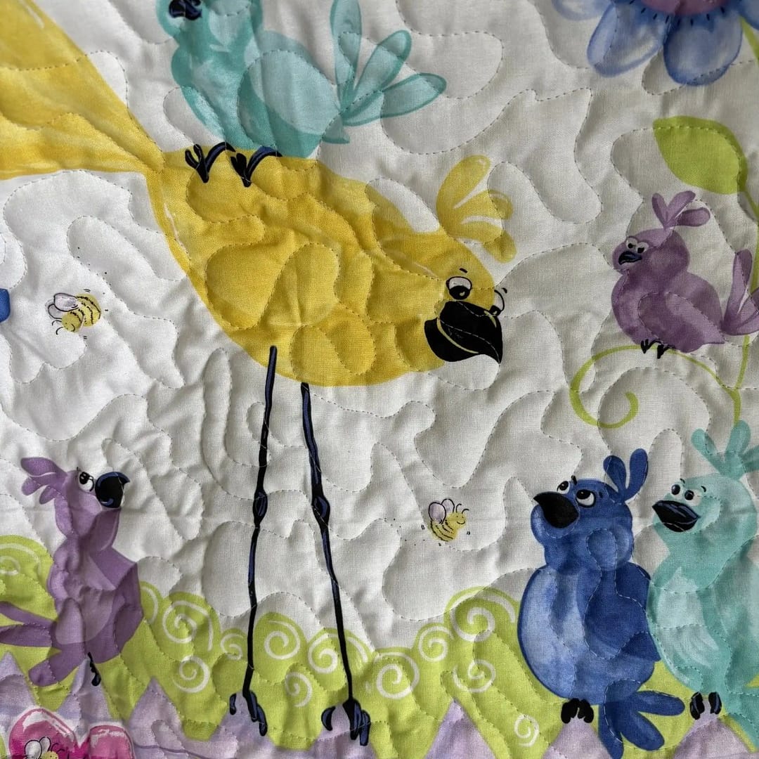 Bird Song in bloom baby quilt yellow bird detail