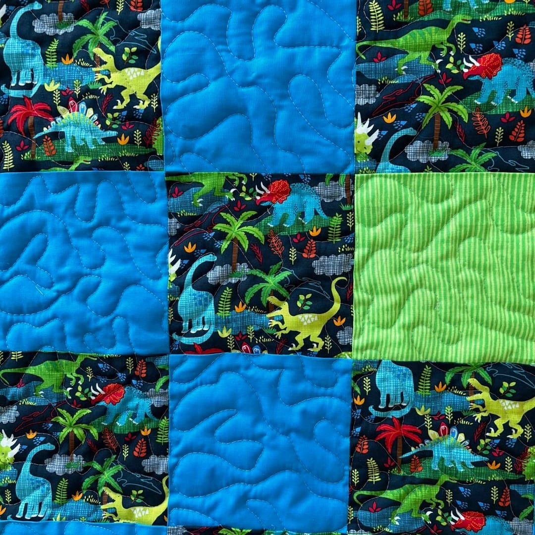 Dinosaur Dreams Baby Quilt detail of blue and green patches
