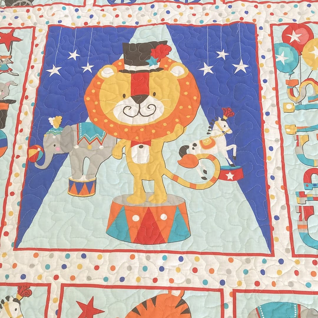 Circus Parade Baby Quilt with detail of lion