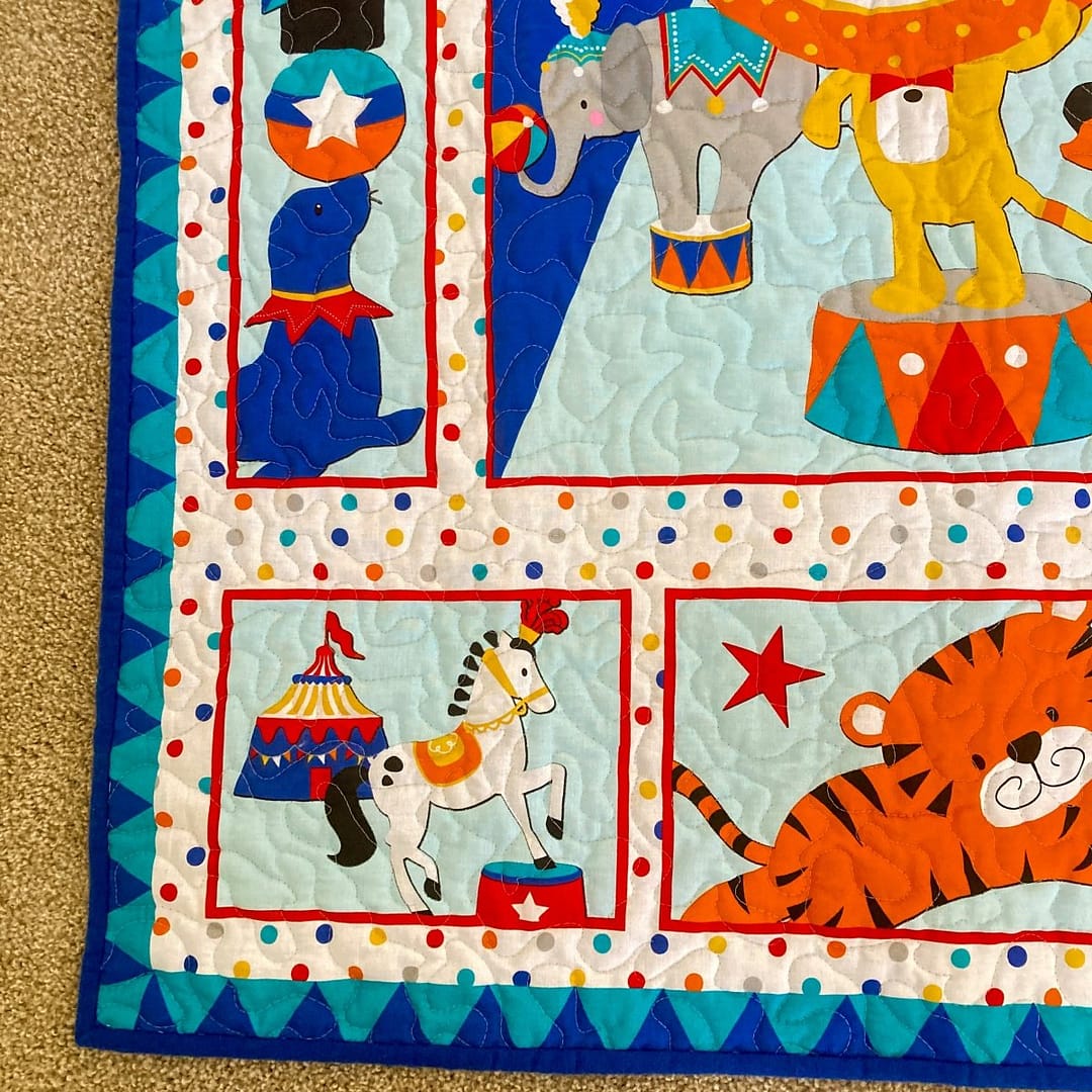Circus Parade Baby Quilt with detail of poodle