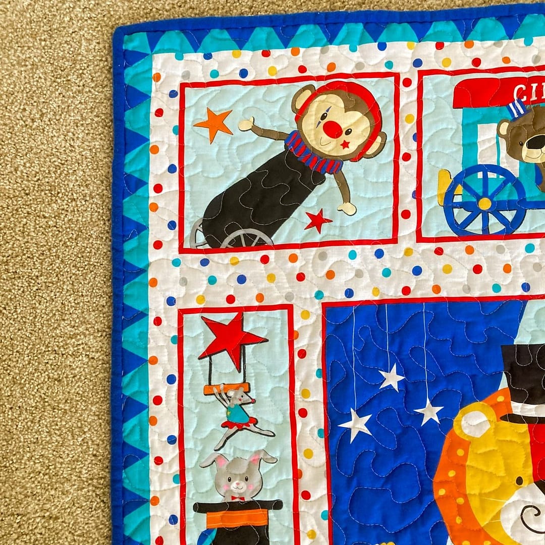 Circus Parade Baby Quilt with detail of monket