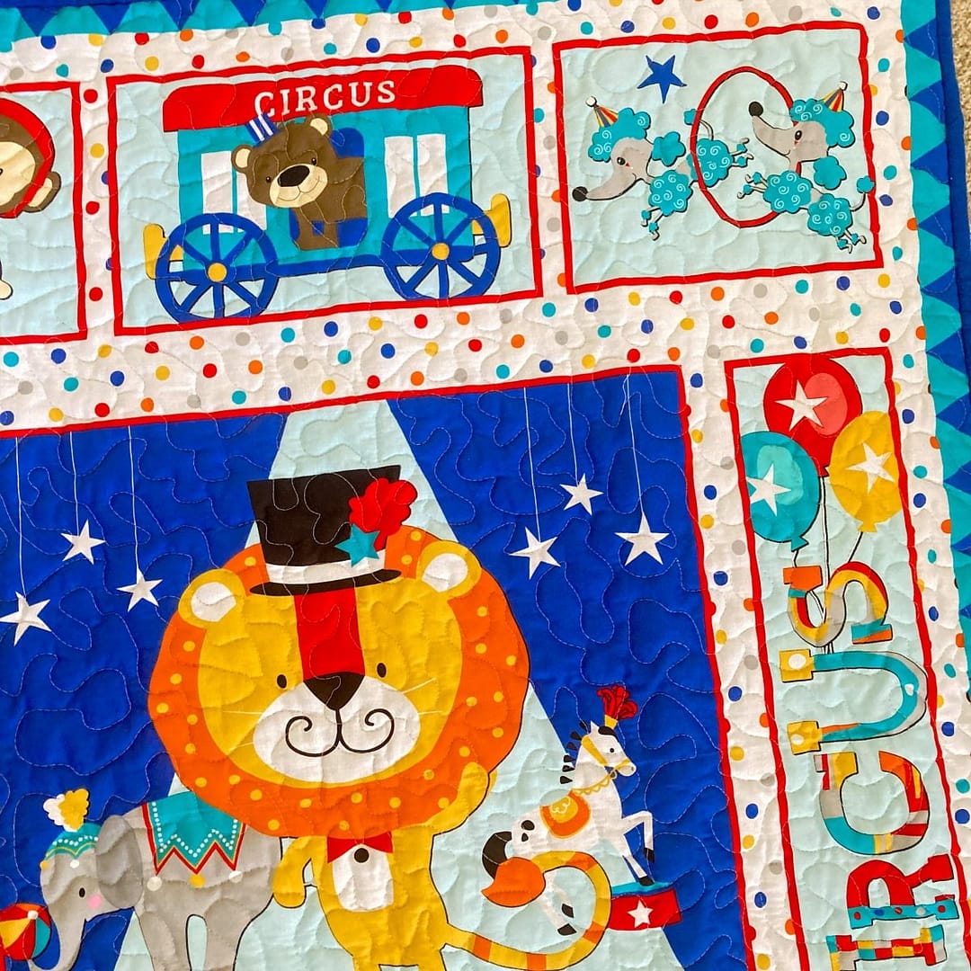 Circus Parade Baby Quilt with detail of top corner