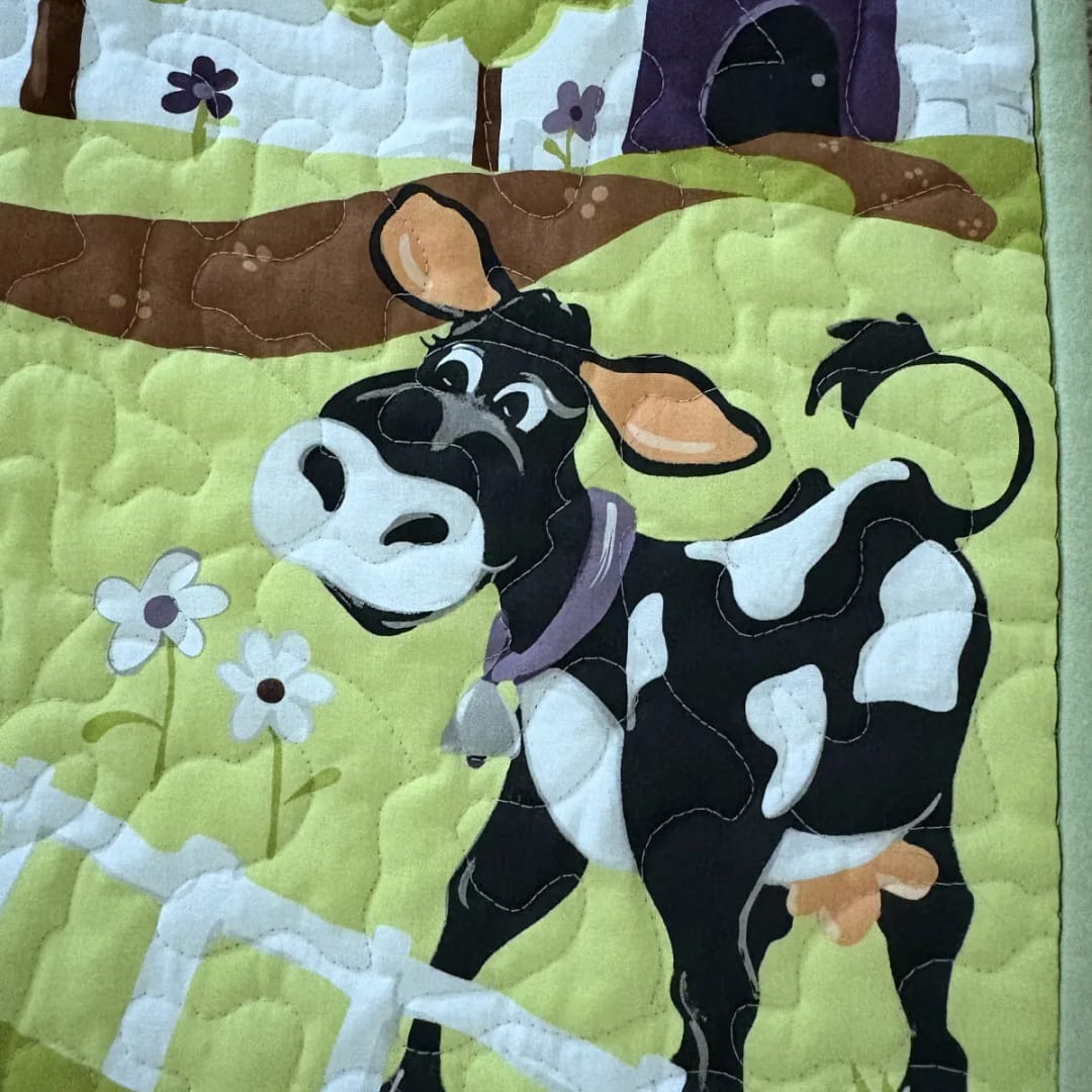 Barnyard Buddies Baby Quilt with cow in field