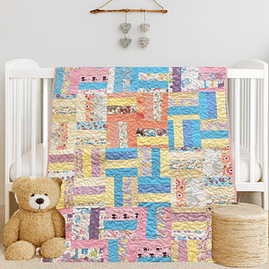 Handmade pastel patchwork quilt for toddlers featuring floral and animal prints.